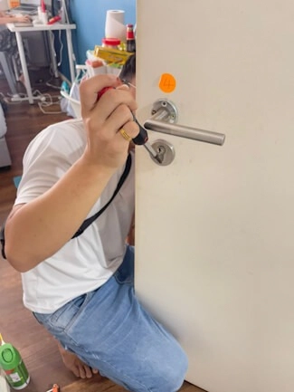 A smart lock keypad and fingerprint reader on an installed door.