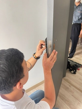 A completed smart door lock installation on a bedroom door.