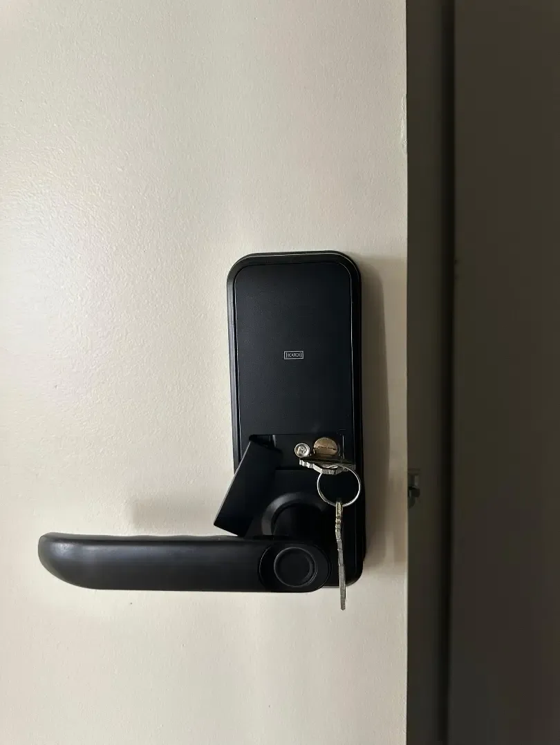 The interior panel of an installed smart door lock.