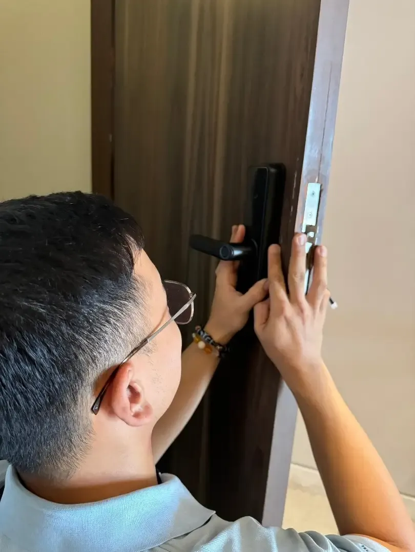 A smart door lock being fitted during installation.