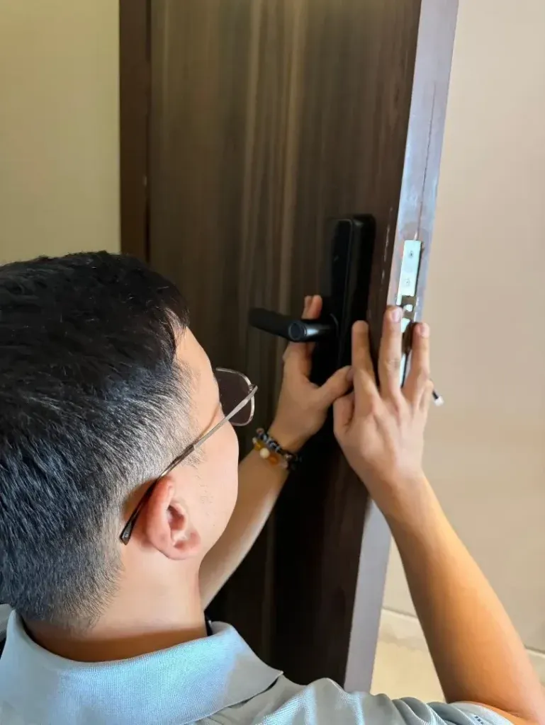 A smart door lock installed across a row of rental rooms.