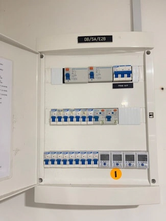 A smart meter mounted inside a distribution board.
