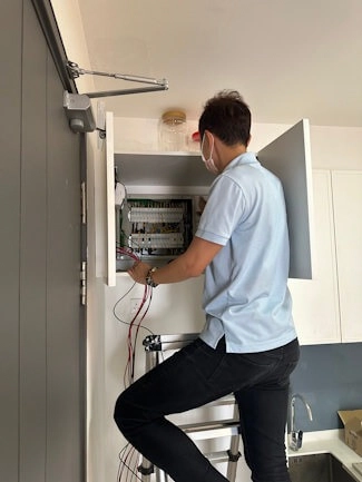 Smart meters wired into a distribution board alongside the circuit breakers.