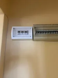 A smart meter fitted on a DIN rail.